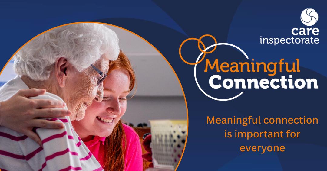 Elderly woman and carer smiling in a care home setting.
